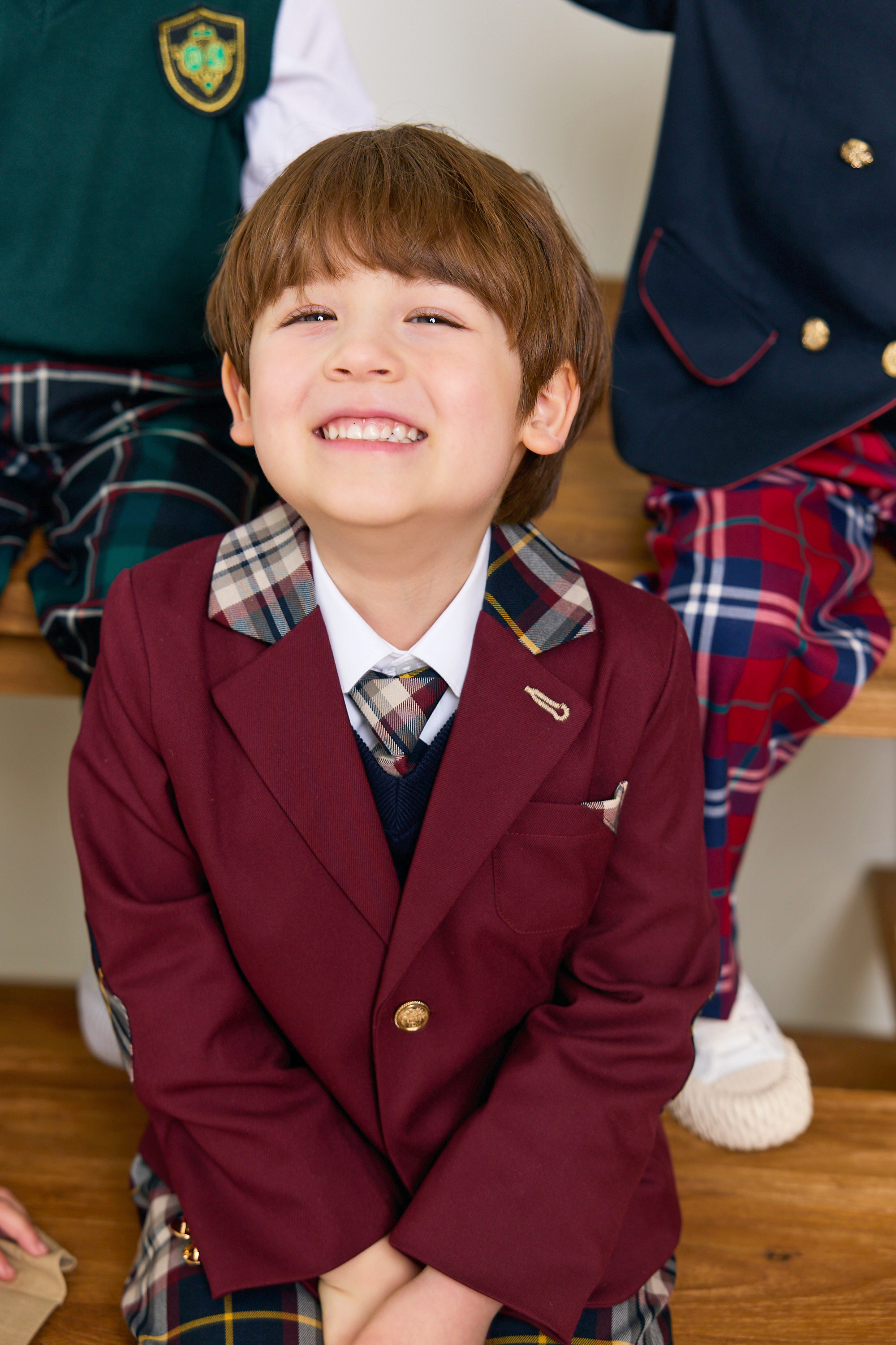 Child smiling in THE YOOA uniform